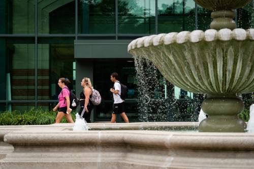 fountain and students walking